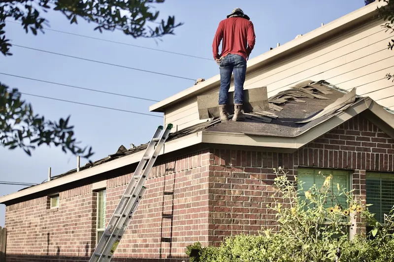 Professional roofer working on a residential roof in Delta